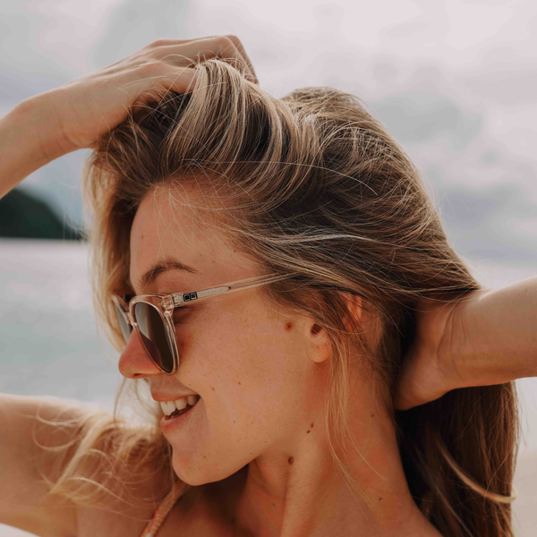 Imogen Caldwell looking to the side wearing crystal OTIS eyewear sunglasses