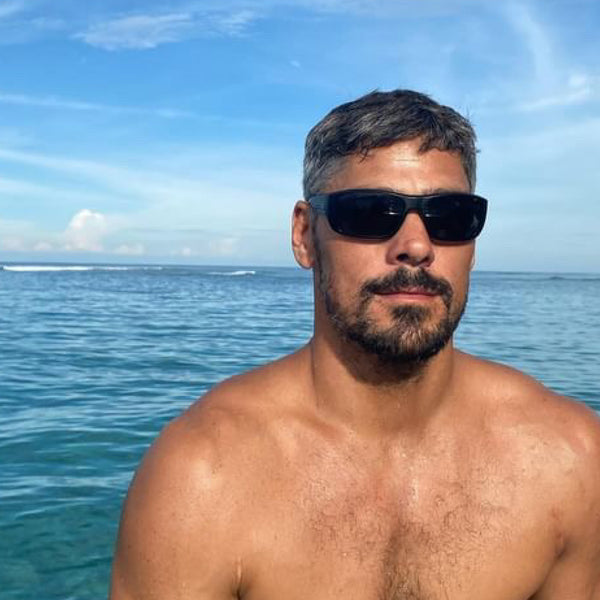 Jay Davie on a boat wearing black wrap around sunglasses