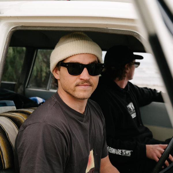 Two men in a car wearing wayfarer sunglasses