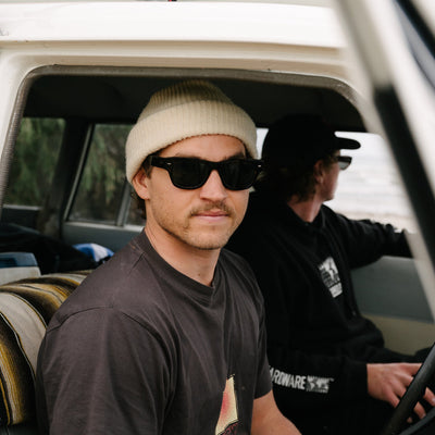 Two men in a car wearing wayfarer sunglasses