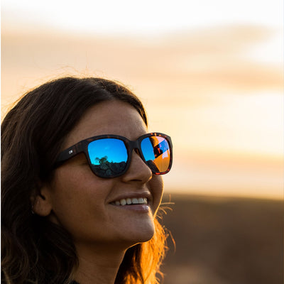 Woman wearing OTIS Eyewear round cat eye sunglasses and smiling