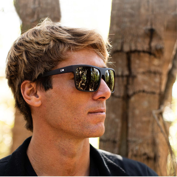 Eric Geiselman wearing black OTIS eyewear sunglasses facing the side