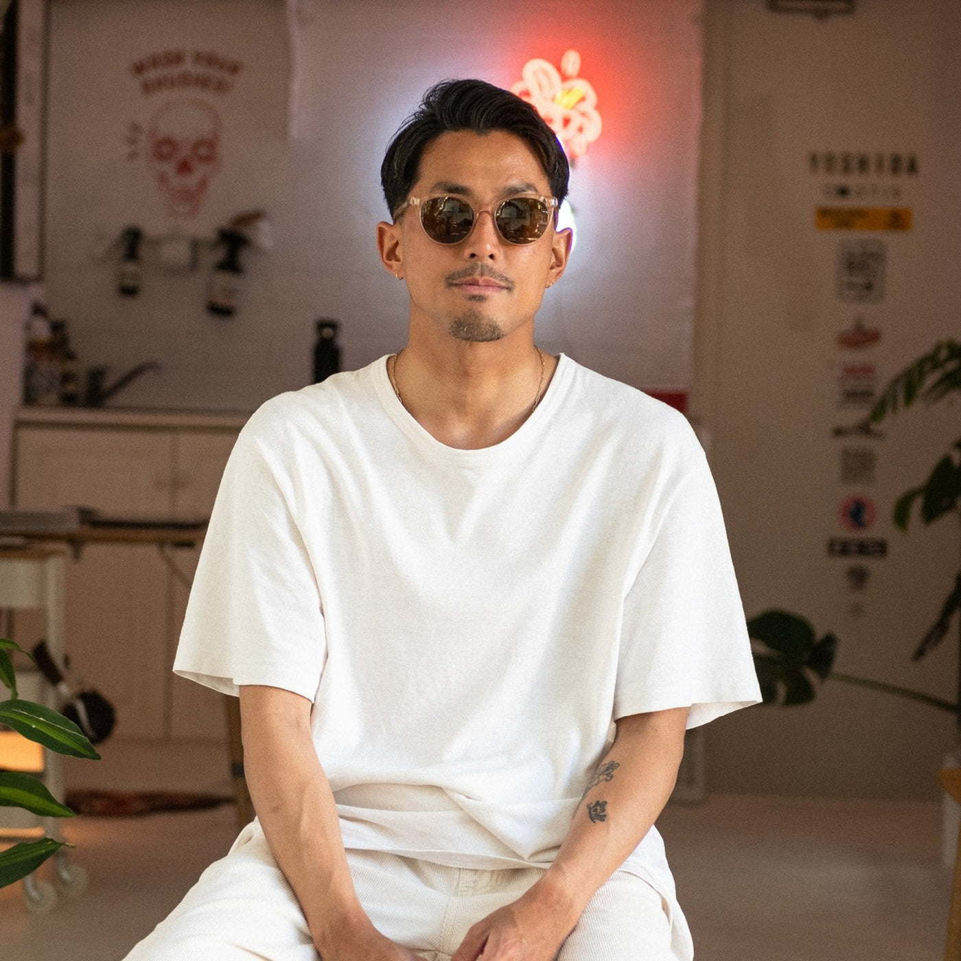 Kentaro Yoshida wearing crystal sunglasses and a white shirt and pants