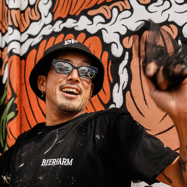 Artist Kentaro Yoshida wearing clear frame sunglasses with blue lenses